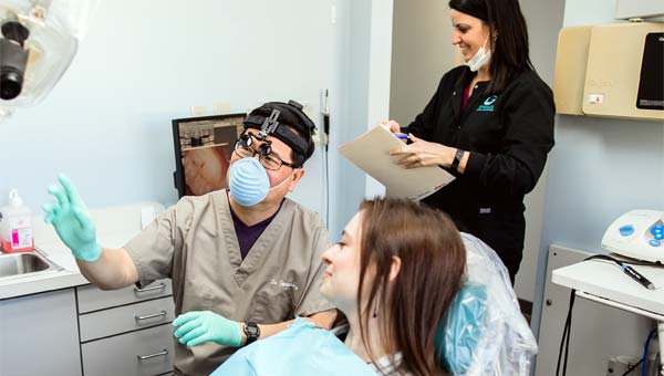 doctor gowasack with a dental patient